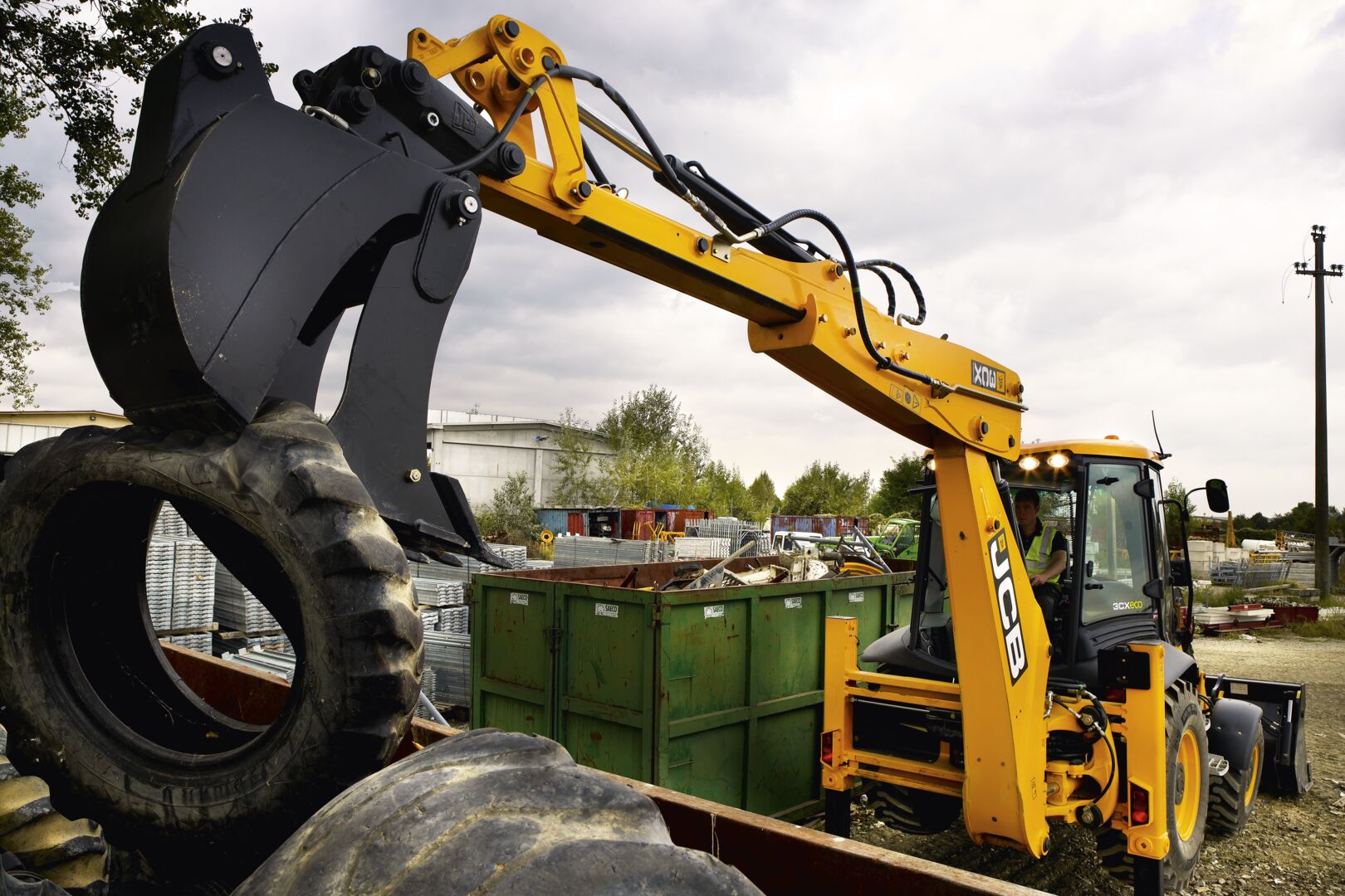 JCB Backhoe attached with a JCB Jaw bucket lift a tyre