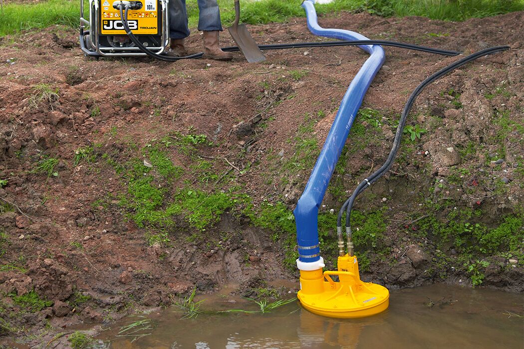 JCB Trash Pump in a pool of water attached to a trojan powerpack