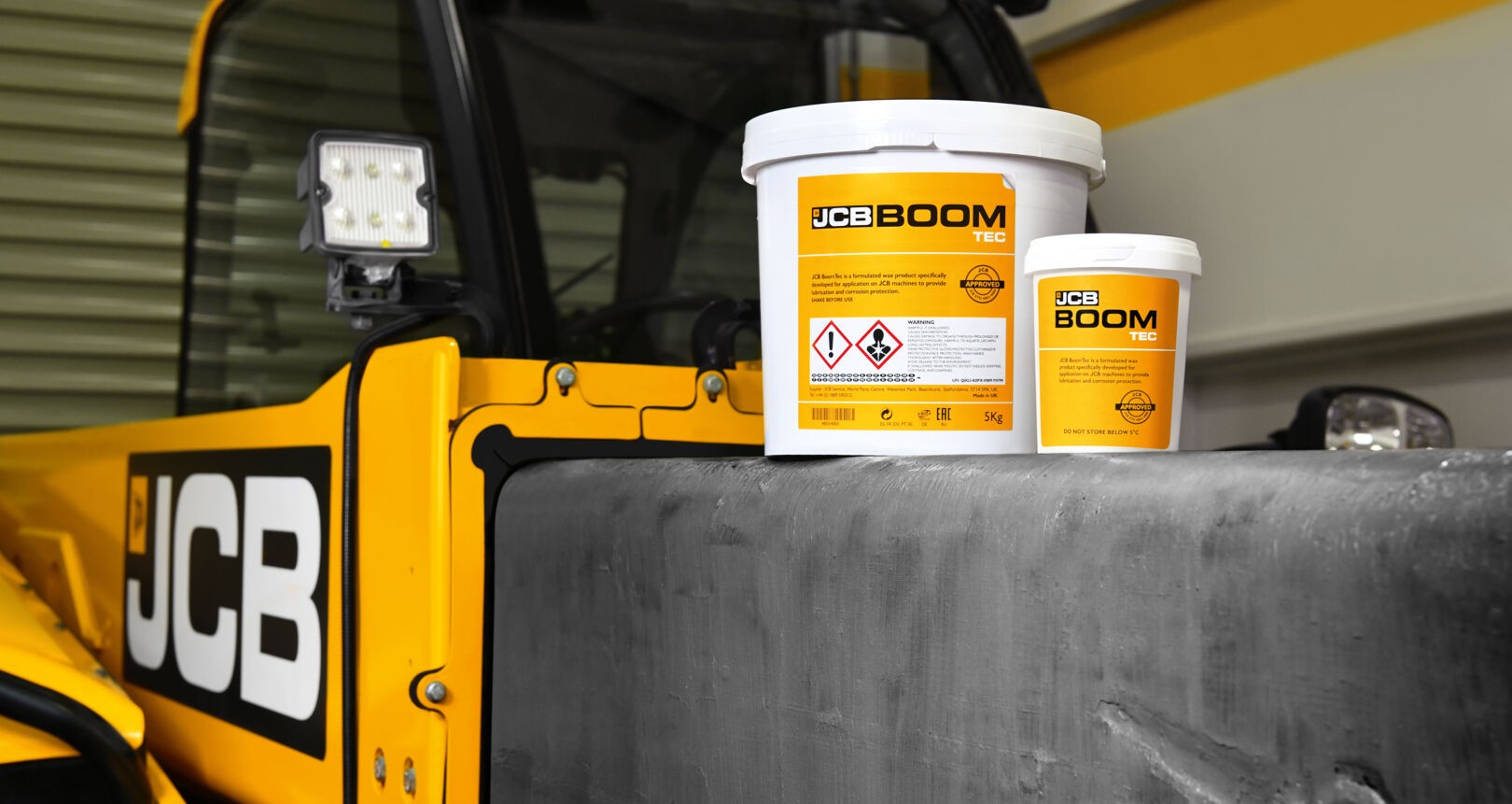 JCB Boom Tec grease tubs displayed on a JCB machine boom