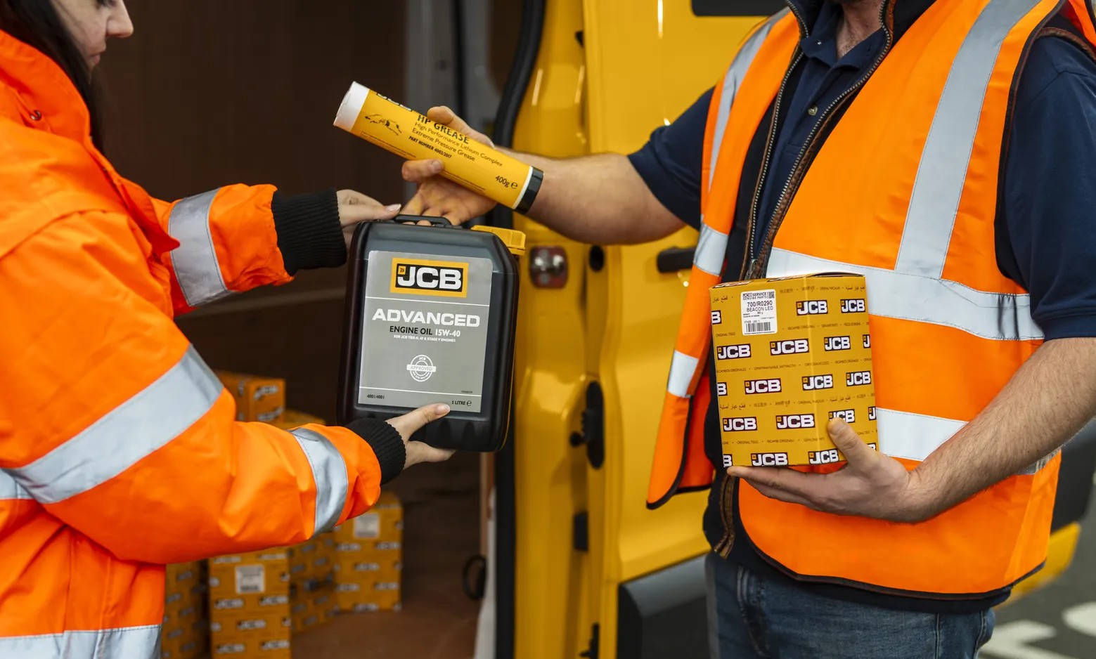 JCB engine oil, grease cartridge, and boxed part being handed over at a service van